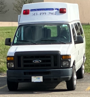 A Gray Van Parked Beside the White Concrete Building